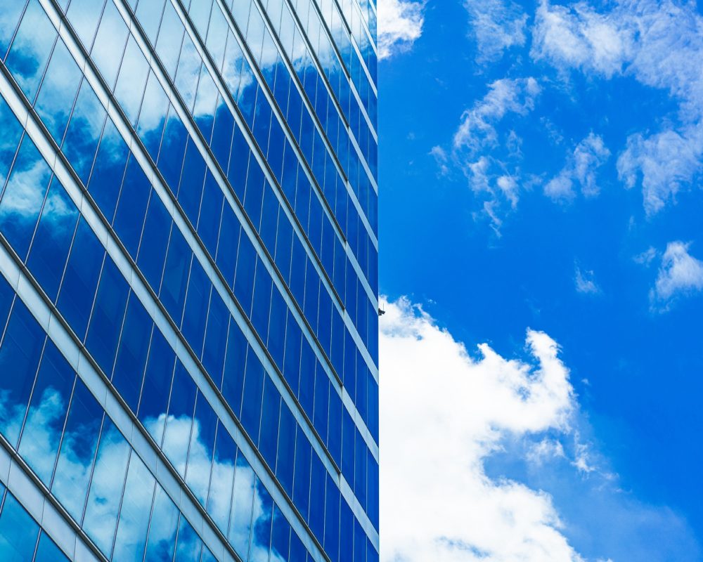 underside panoramic and perspective view to steel blue glass high rise building skyscrapers, business concept of successful industrial architecture